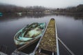 High angle shot of a dirty old boat parked near the pier in the lake Royalty Free Stock Photo