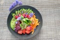 High angle shot of fresh summer salad with blue cornflowers, avocado, cherry tomatoes, cucumber, radicchio, redlish, iceberg Royalty Free Stock Photo