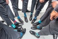 High angle shot of the groomsmen standing in a circle and showing their colorful socks Royalty Free Stock Photo