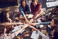 Because teams who eat together, stay together. High angle shot of a group of creative workers piling their hands while