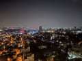 High angle shot of a hazy city with colorful lights at night