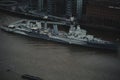 High angle shot of the HMS Belfast warship cruising on the River Thames in London, England Royalty Free Stock Photo