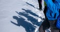 High angle shot of kids' shadows having fun, cast on snow