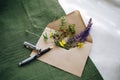 High angle shot of lavender, small yellow flowers, and in an envelope, and a pen Royalty Free Stock Photo