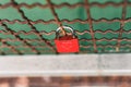 High angle shot of a love lock attached to a grate