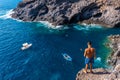 High angle shot of a masculine male standing on top of a cliff in Poris de Candelaria