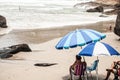 High angle shot of men sitting on the beach of Florianopolis, Brazil