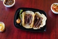 High angle shot of Mexican beef tacos with fried jalapeno, onion with salsa and a salad Royalty Free Stock Photo