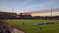 High-angle shot of a New Mexico United playing soccer in the Albuquerque Isotopes stadium at sunset