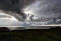 High angle shot of the ocean shore and the dark cloudy depressing sky in the background Royalty Free Stock Photo