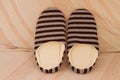 High angle shot of a pair of striped warm slippers