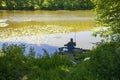 High angle shot of a person coarse fishing at a lake in Wiltshire, UK in the early morning