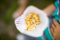 High angle shot of a person holding a paper bag with popcorn in it Royalty Free Stock Photo