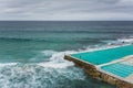 High angle shot of a person standing near a swimming pool near the sea