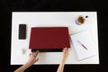 High angle shot of a person working at a work desk with a laptop, a cup of coffee, and mobile phone Royalty Free Stock Photo