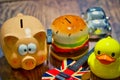 High angle shot of a piggy bank and other kids money bank on a wooden table - savings concept