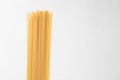 High angle shot of a pile of uncooked spaghetti isolated on a white surface