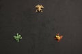 High angle shot of a plastic frog toy miniatures on a black surface Royalty Free Stock Photo