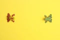 High angle shot of a plastic frog toy miniatures on a yellow surface Royalty Free Stock Photo