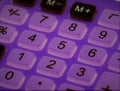 High angle shot of a purple calculator in lights
