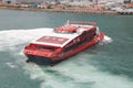 High angle shot of a red high speed ferry on the water in Hong Kong