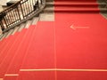 High angle shot of a red stairway with the direction marked on the ground Royalty Free Stock Photo