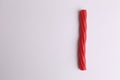 High angle shot of a red stick candy isolated on a white surface