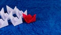 High angle shot of Red & white paper boats in sea made of thick textured craft paper with copy space on the right