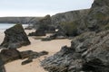 High angle shot of the rocks on the sand-covered beach captured in Bedruthan Steps Downhill, UK Royalty Free Stock Photo