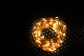 High angle shot of a roll of copper wire with shiny rice lights Royalty Free Stock Photo