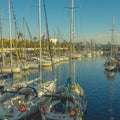 High angle shot of the sailing boats on the water by the port under the blue sky Royalty Free Stock Photo