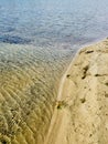High angle shot of a sandy beach and sea waves with interesting textures Royalty Free Stock Photo