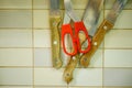 High angle shot of scissors put on three knives Royalty Free Stock Photo