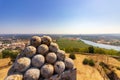 High angle shot of a sculpture of multiple round shapes with a landscape in the background