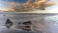 High angle shot of a sea with rocks under a blue cloudy sky Royalty Free Stock Photo