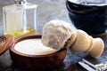 High angle shot of shaving cream and brush on a grey surface Royalty Free Stock Photo