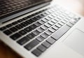 High angle shot of a silver and black laptop on a wooden table Royalty Free Stock Photo