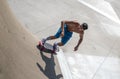 High angle shot of a skateboarder doing tricks on his skateboard during a sunny day Royalty Free Stock Photo