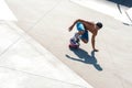 High angle shot of a skateboarder doing tricks on his skateboard during a sunny day Royalty Free Stock Photo