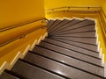 High angle shot of stairs in a building with yellow walls Royalty Free Stock Photo