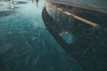 High angle shot of a stone wet surface with a reflection of a round building