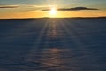 High angle shot of the sun shining over the beautiful snow-covered field Royalty Free Stock Photo