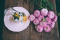 High angle shot of a table with beautiful pink flowers and a delicious dessert with blueberries Royalty Free Stock Photo