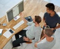 Taking care of business. High angle shot of three designers working together on a project in an office. Royalty Free Stock Photo