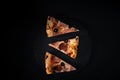 High angle shot of three pieces of pizza on a black surface Royalty Free Stock Photo