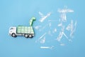 High Angle Shot Of A Toy Garbage Truck And Plastic Waste On A Blue Background