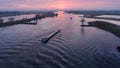 High angle shot of typical dutch landscape with a transport ship vessel in river lek during sunset Royalty Free Stock Photo