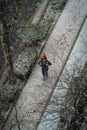 High-angle shot of an unrecognizable man carrying his child on his shoulders while it is snowing