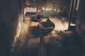 High angle shot of a vacant armchair in the center of a ruined room in an old building