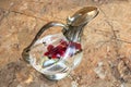 High angle shot of water with flowers and coffee beans in a vintage jug with a cap Royalty Free Stock Photo